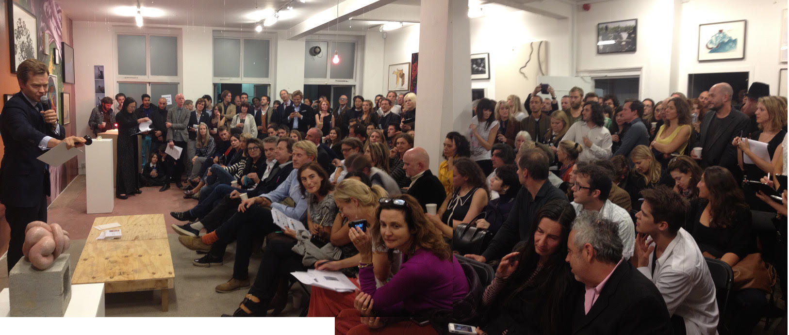 Oliver Barker from Sotheby's holding the auction in Sarah Lucas' exhibition at Sadie Coles HQ